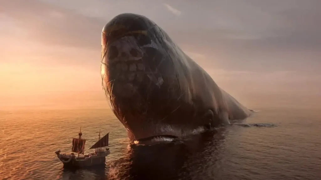 Laboon, the colossal whale with Luffy's Straw Hat Jolly Roger painted on his forehead, rises from the sea beside the Going Merry at sunset in One Piece live-action Season 2 Episode 2, "Good Whale Hunting."