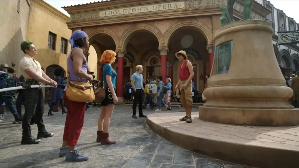 The Straw Hat Pirates gather in Loguetown Square as Luffy stands near the execution platform in One Piece Season 2, Episode 1, "The Beginning and the End."