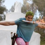 Zoro fights with his signature three-sword style, holding one katana in his mouth while wielding two flaming swords in front of a giant wax structure on Little Garden in Netflix's One Piece Season 2 Episode 5, "Wax On, Wax Off."