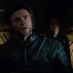 Hugh Jackman as Wolverine in black leather suit looking upward, flanked by Storm, Jean Grey, and Cyclops in X-Men (2000).