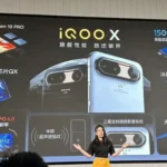 A presenter standing in front of a large display screen presenting the key specifications and features of the iQOO X smartphone.