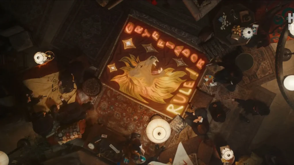 Overhead aerial view of the Gryffindor common room with a glowing, enchanted Quidditch banner on the floor.